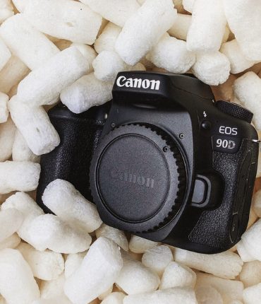 A camera nestled in protective packing peanuts