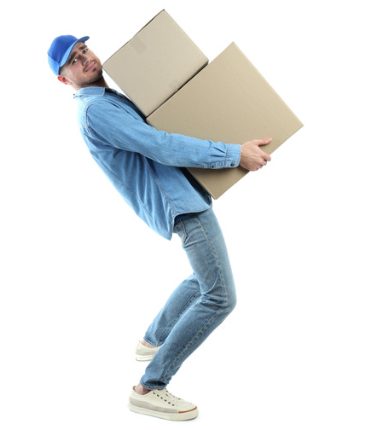 Man carrying two large cardboard boxes on his back