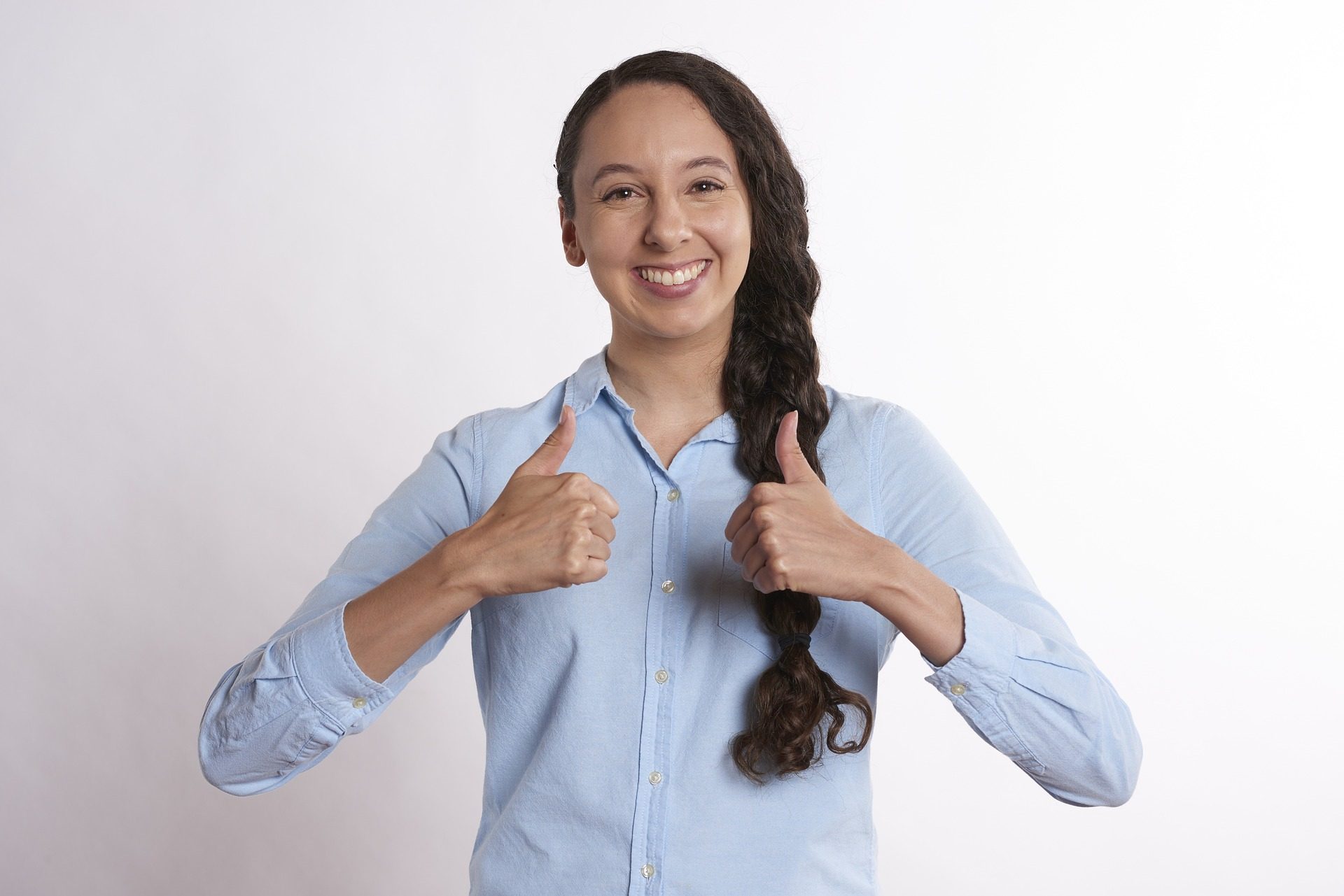 Smiling woman giving two thumbs up